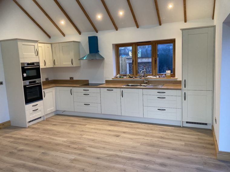 Fitted kitchen under a vaulted timber ceiling